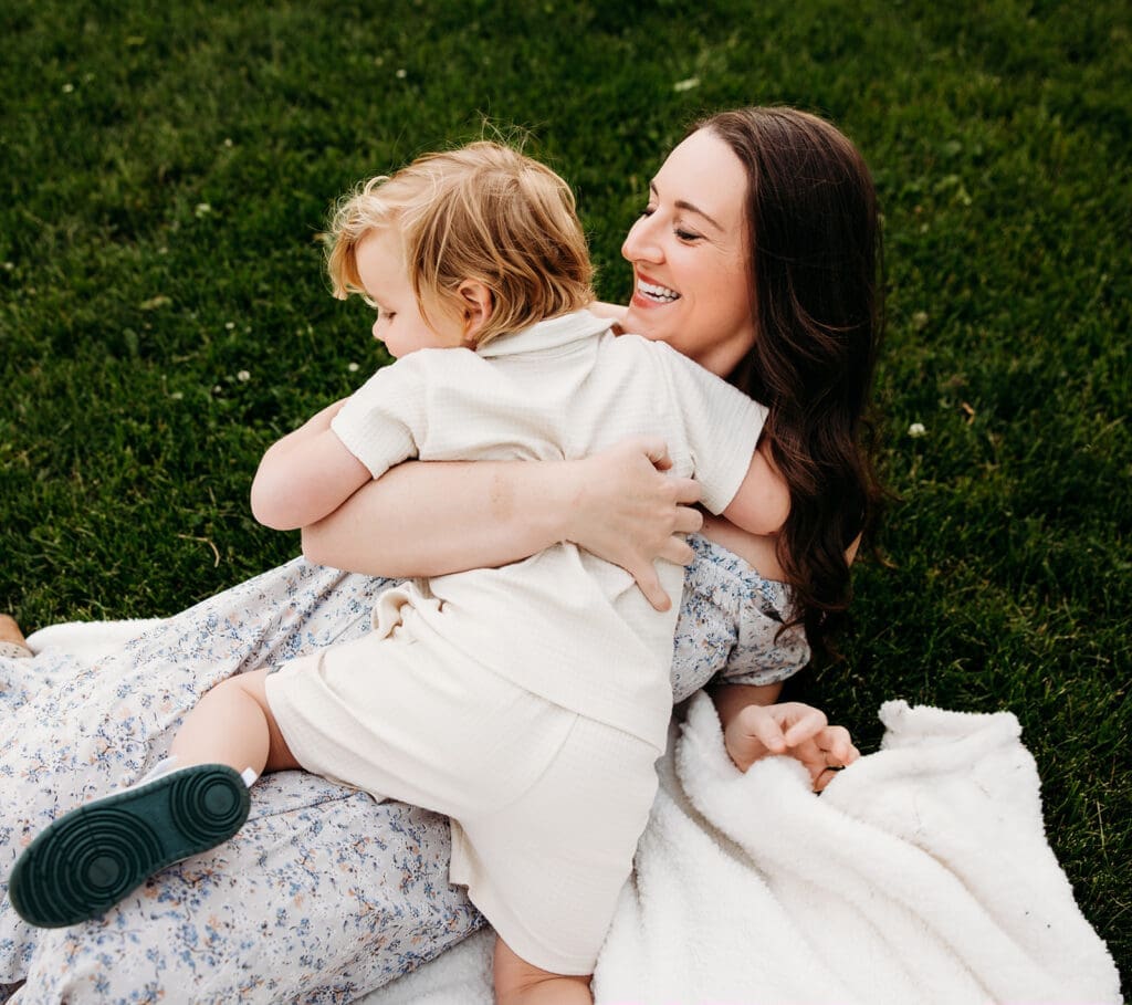  Close-up of toddler hugging mother during emotional family session