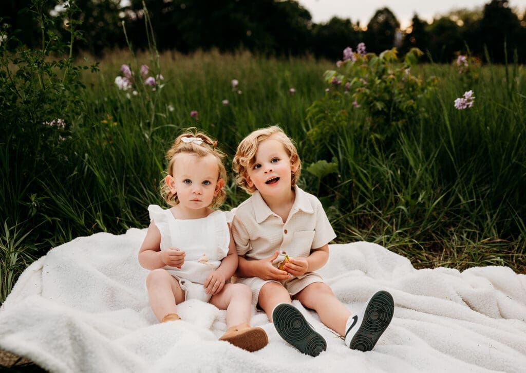 two toddlers enjoying candy during a naperville family photo session