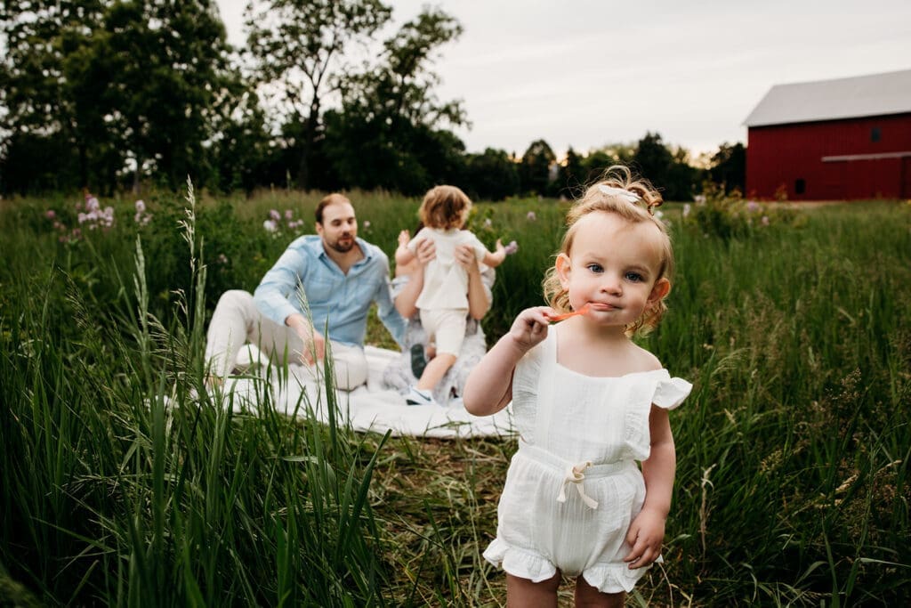close up of toddler and family eating candy during an emotional family session 