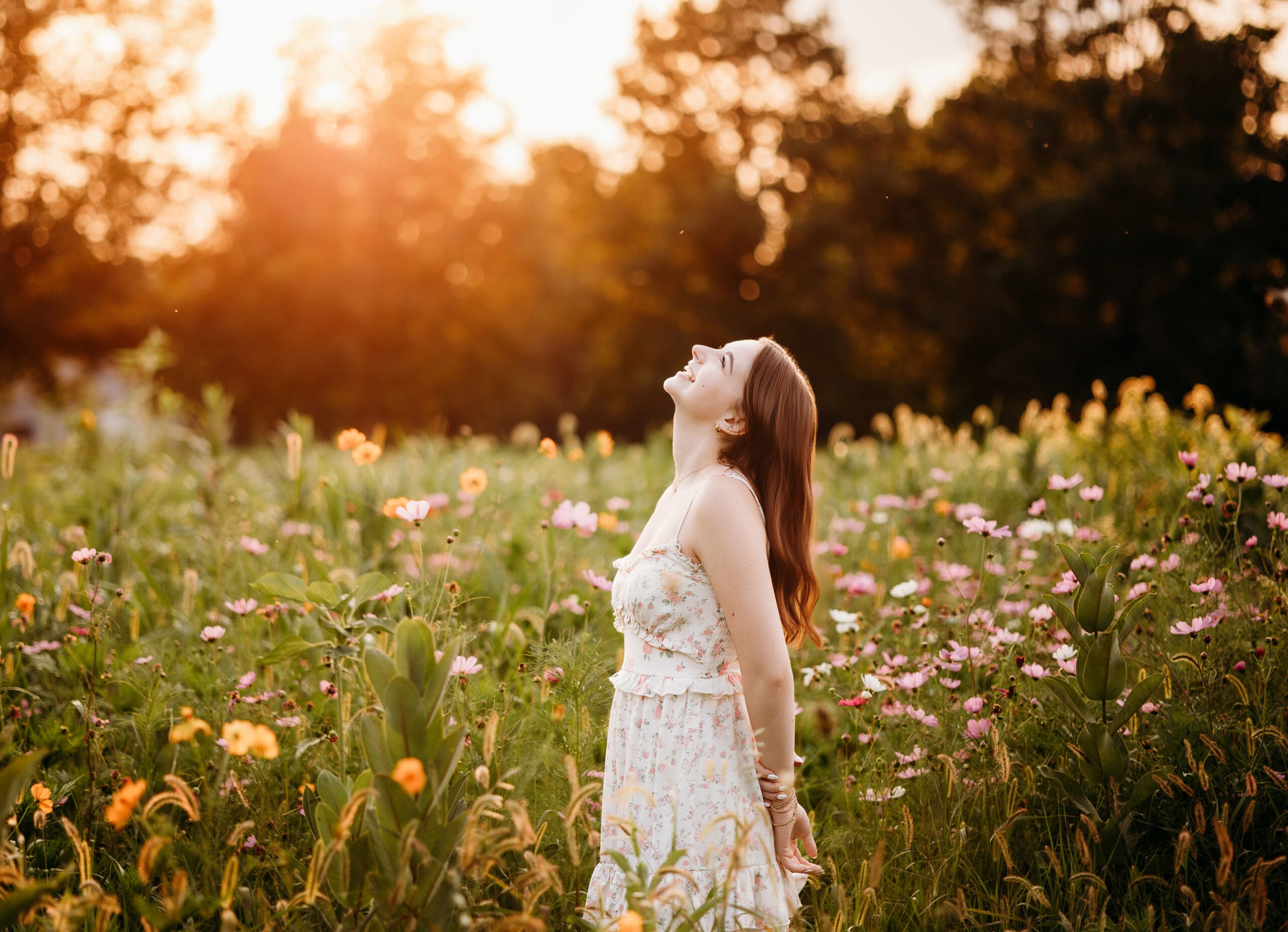 A girl smiling in a field of wildflowers in the chicago suburbs during a senior photography session.