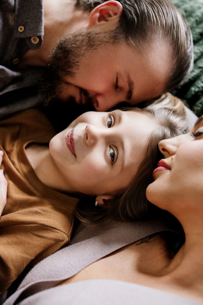 Family of three lying close together during an intimate in-home lifestyle session by Graceful Joy Photography Naperville, IL